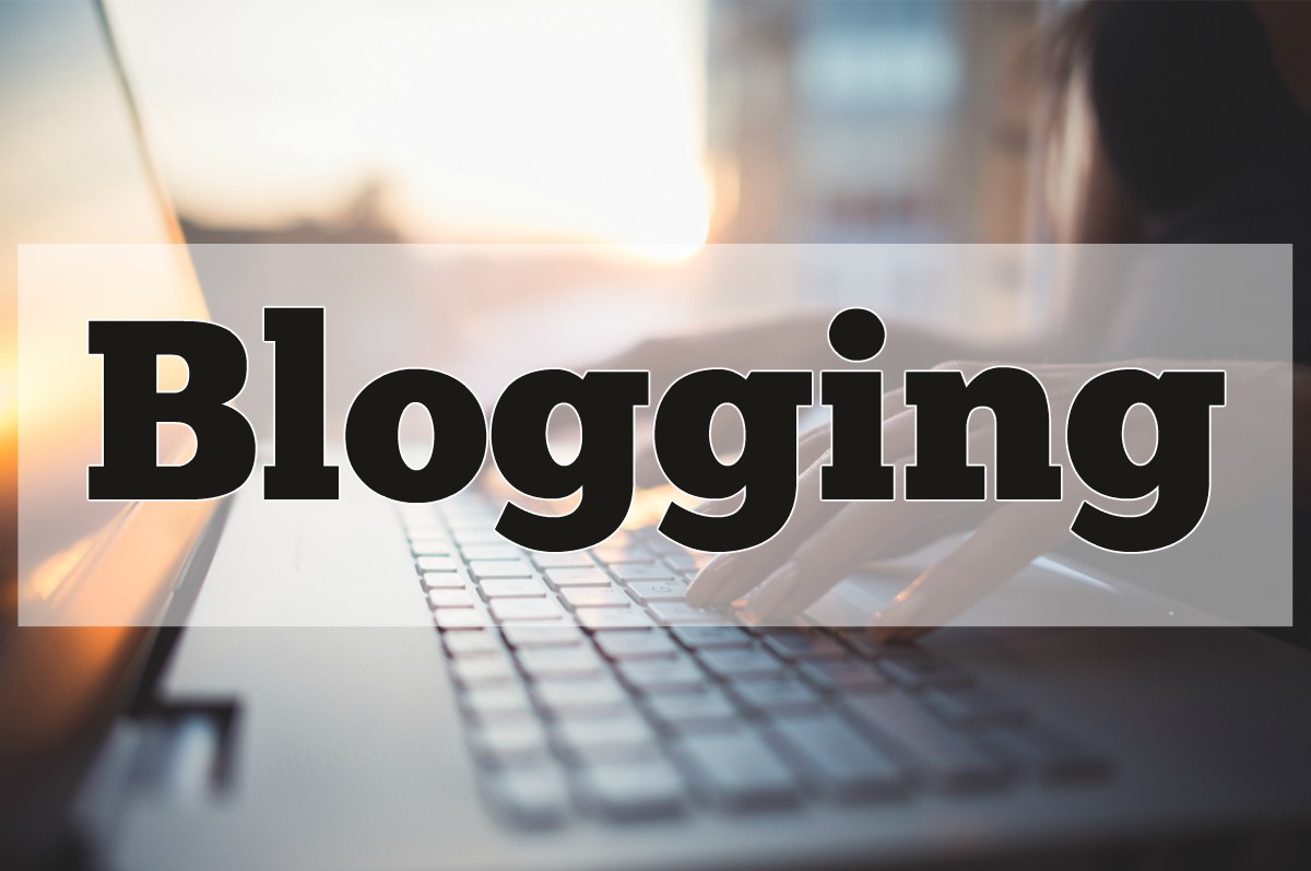 A person typing on a laptop keyboard with the word blogging overlaid on the screen.