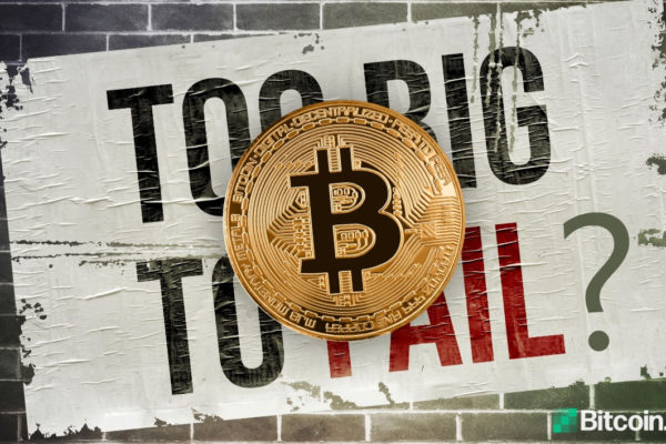 A Bitcoin logo sits atop a distressed sign asking if Bitcoin is too big to fail.